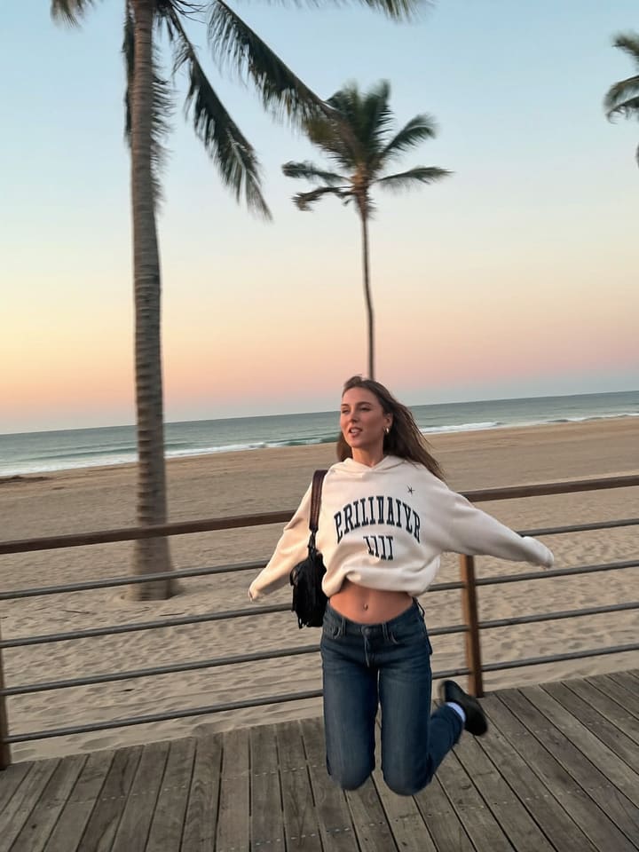 Mid-air jump, knees up at Venice boardwalk